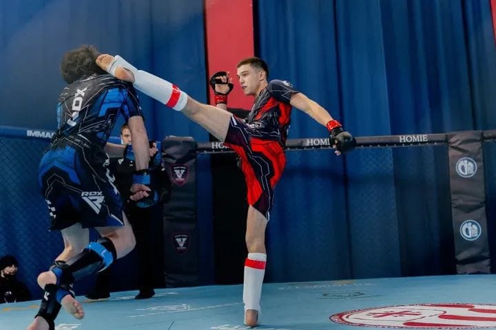 IRAO fighter landing a high kick in the cage